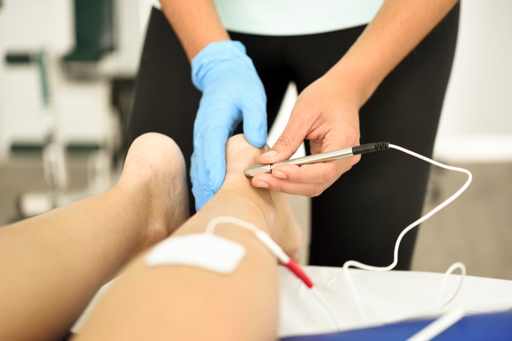 Physiotherapist assisting patient with rehabilitative therapy